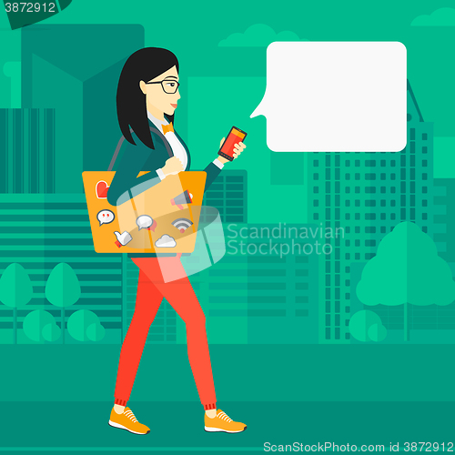 Image of Woman walking with smartphone.