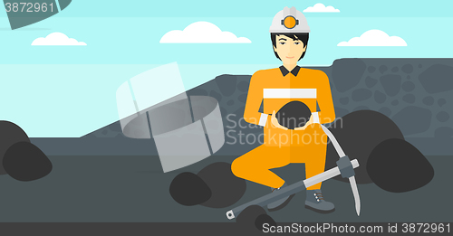 Image of Miner holding coal in hands.