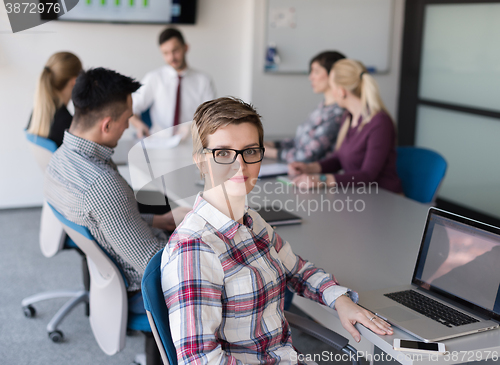 Image of portrait of young business woman at office with team on meeting 