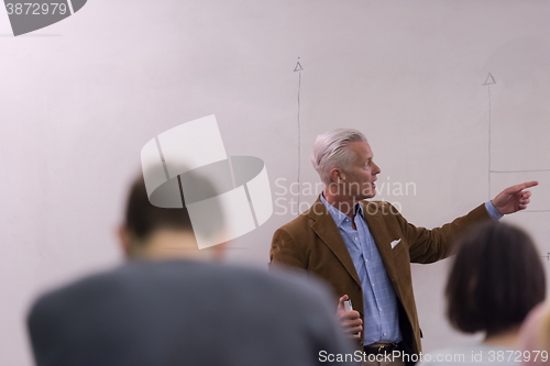 Image of teacher with a group of students in classroom