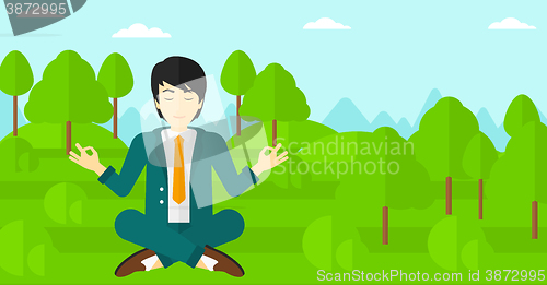 Image of Businessman meditating in lotus pose.