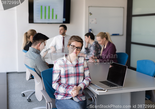 Image of portrait of young business woman at office with team on meeting 