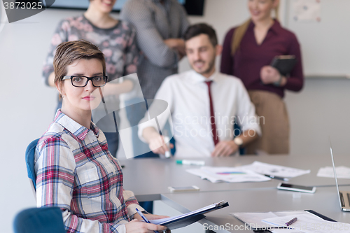 Image of portrait of young business woman at office with team on meeting 