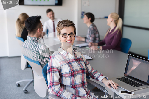 Image of portrait of young business woman at office with team on meeting 