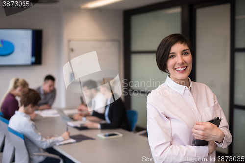 Image of hispanic businesswoman with tablet at meeting room