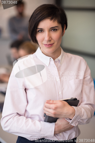 Image of hispanic businesswoman with tablet at meeting room