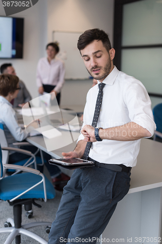 Image of young business man with tablet at office meeting room