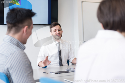 Image of young business people group on team meeting at modern office