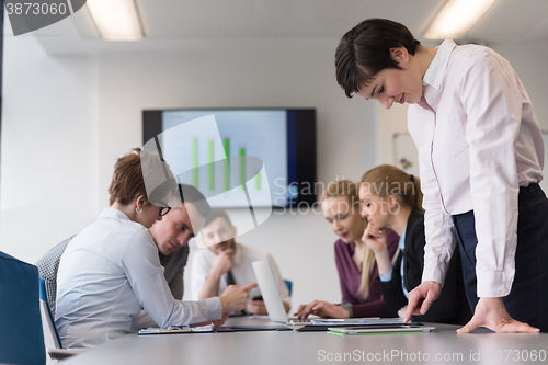 Image of young  woman using  tablet on business meeting