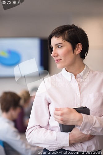 Image of hispanic businesswoman with tablet at meeting room