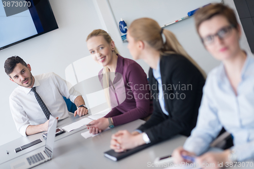 Image of young business people group on team meeting at modern office