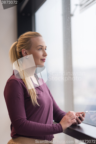 Image of business woman using smart phone at office