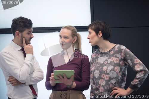 Image of young business people group working on tablet
