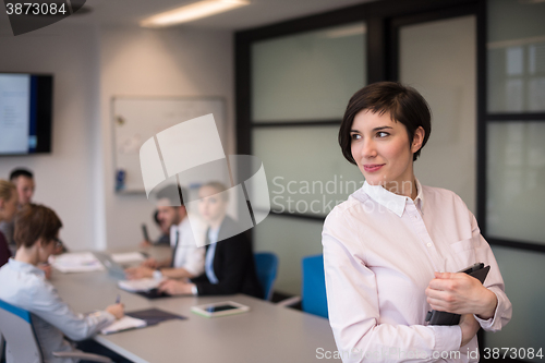 Image of hispanic businesswoman with tablet at meeting room