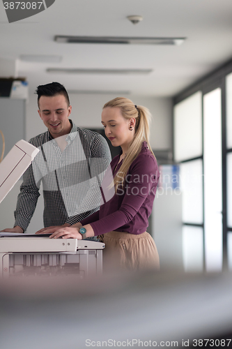 Image of business couple copy documents