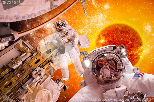 Image of Spacecraft and astronauts in space on background sun star