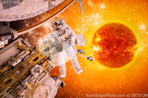 Image of Spacecraft and astronauts in space on background sun star