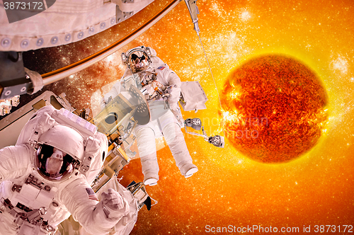 Image of Spacecraft and astronauts in space on background sun star