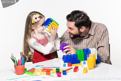Image of Father and daughter playing educational games together 