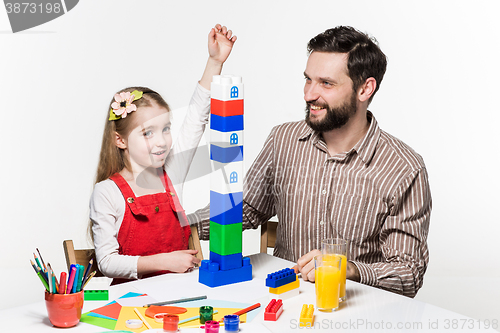 Image of Father and daughter playing educational games together 