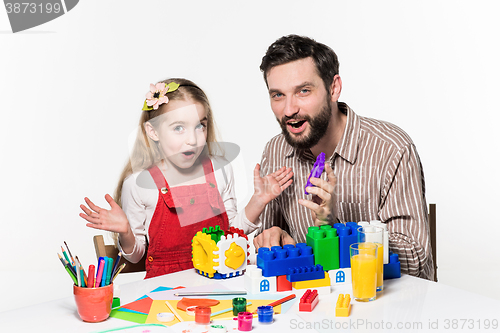 Image of Father and daughter playing educational games together 