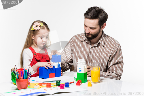 Image of Father and daughter playing educational games together 