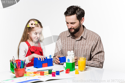 Image of Father and daughter playing educational games together 