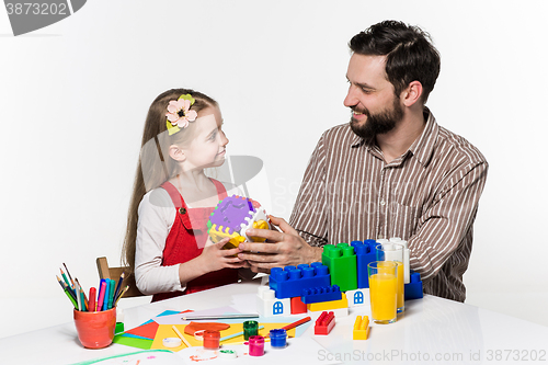 Image of Father and daughter playing educational games together 