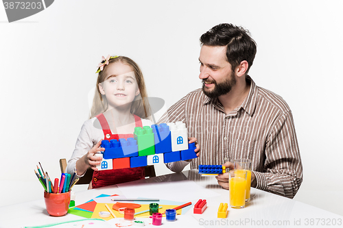 Image of Father and daughter playing educational games together 