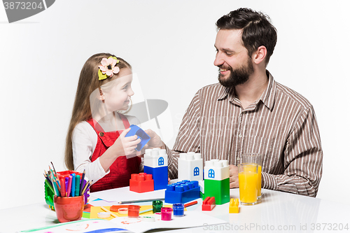 Image of Father and daughter playing educational games together 