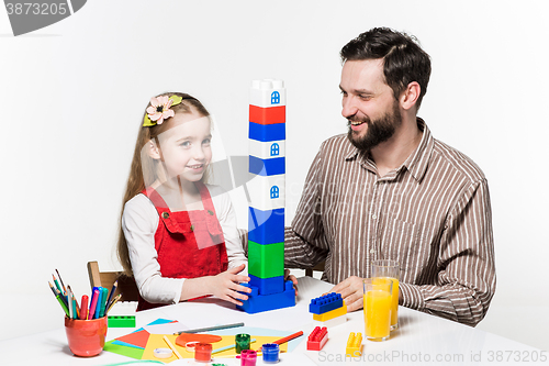 Image of Father and daughter playing educational games together 