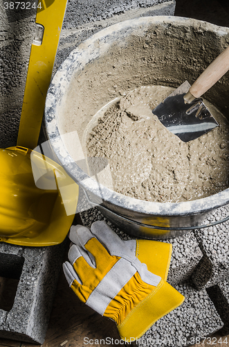 Image of Tools of the mason and  bucket with a solution