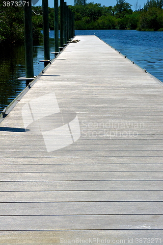 Image of long wooden pier on river in florida