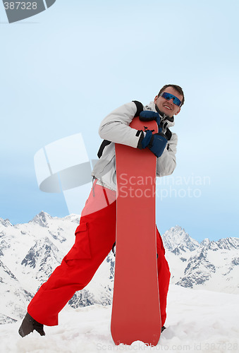 Image of Man with red snowboard