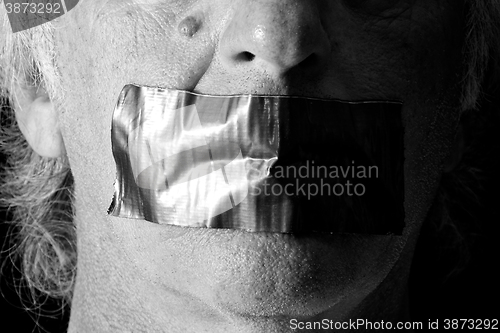Image of black and white mouth duct taped shut