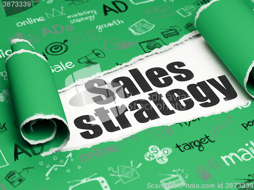 Image of Marketing concept: black text Sales Strategy under the piece of  torn paper