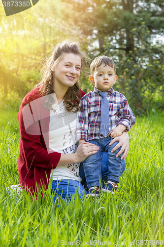 Image of beautiful pregnant woman outdoor with her little boy 