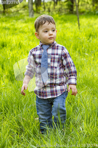 Image of Little boy in the blue shirt jeans