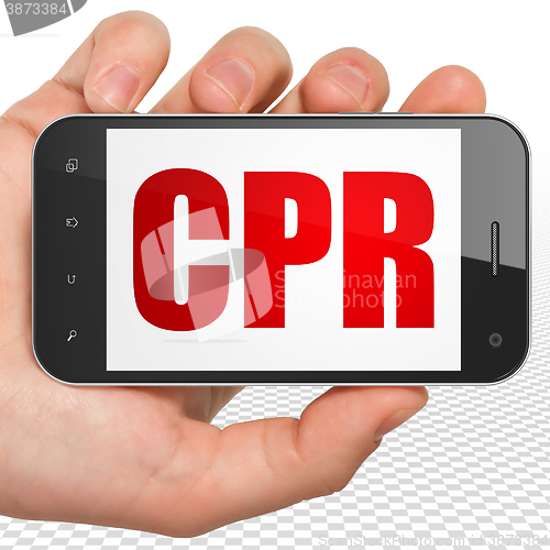 Image of Health concept: Hand Holding Smartphone with CPR on display