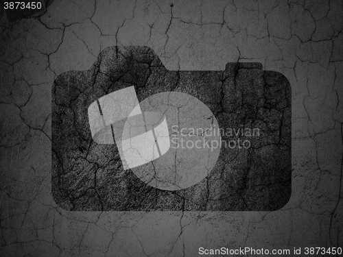 Image of Tourism concept: Photo Camera on grunge wall background