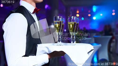 Image of Waiter serving champagne on a tray