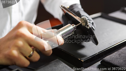 Image of mechanical polishing of the smartphone. Male hands. 