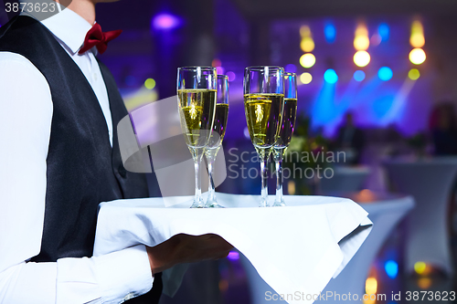 Image of Waiter serving champagne on a tray