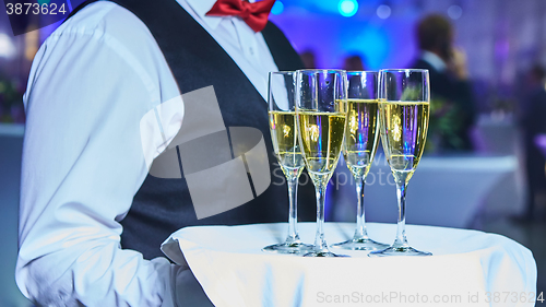 Image of Waiter serving champagne on a tray