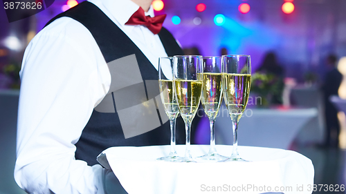 Image of Waiter serving champagne on a tray