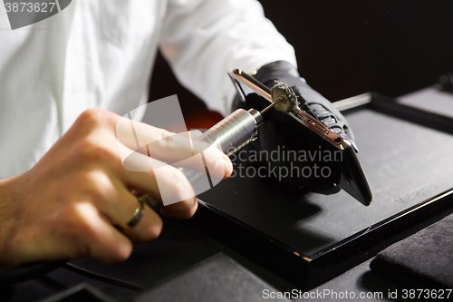 Image of mechanical polishing of the smartphone. Male hands. 