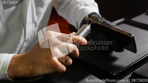 Image of mechanical polishing of the smartphone. Male hands. 