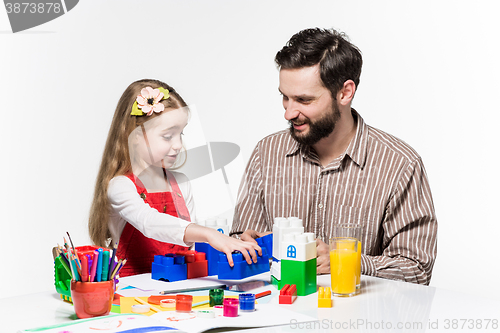 Image of Father and daughter playing educational games together 