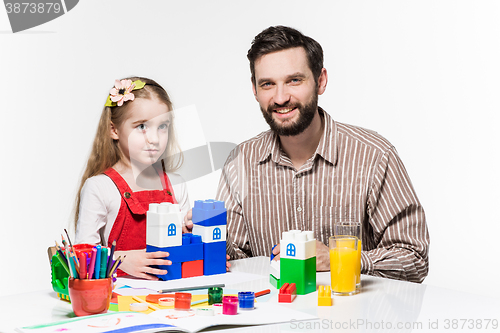 Image of Father and daughter playing educational games together 