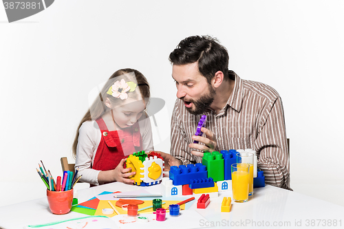 Image of Father and daughter playing educational games together 